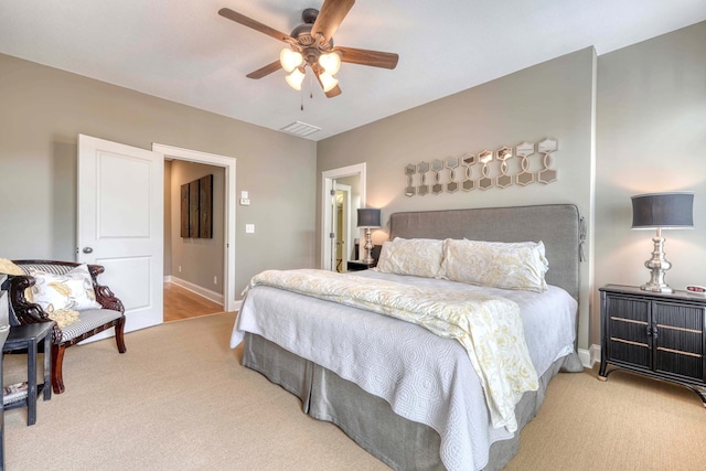 carpeted bedroom featuring visible vents, ceiling fan, and baseboards