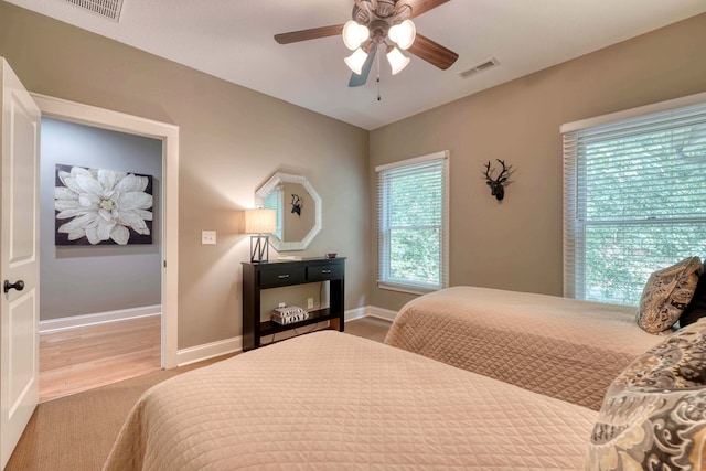 bedroom featuring a ceiling fan, baseboards, and visible vents