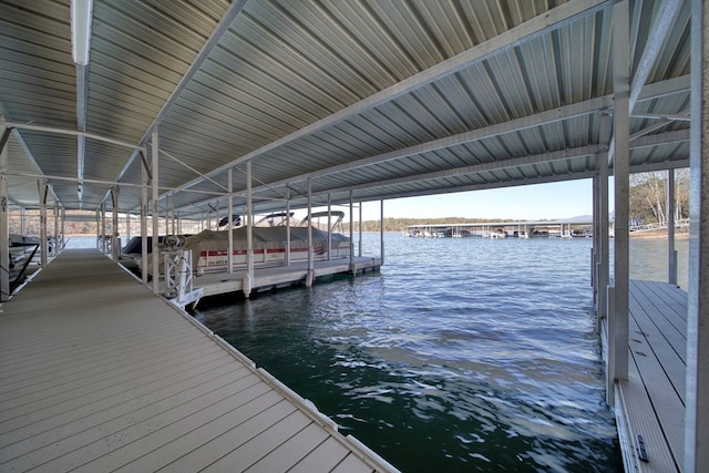 dock area featuring boat lift and a water view