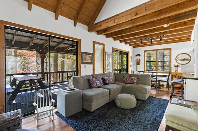 living room featuring wooden ceiling, wood-type flooring, track lighting, and vaulted ceiling with beams