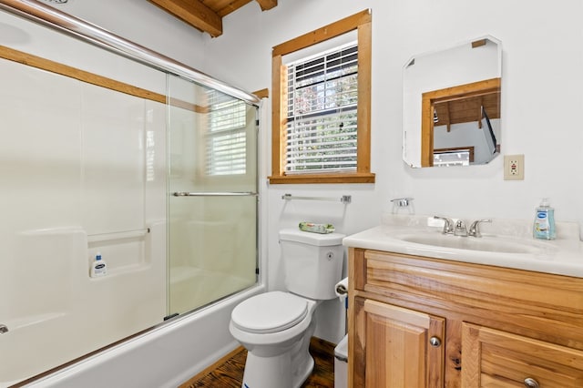 full bathroom featuring hardwood / wood-style floors, toilet, enclosed tub / shower combo, vanity, and beam ceiling