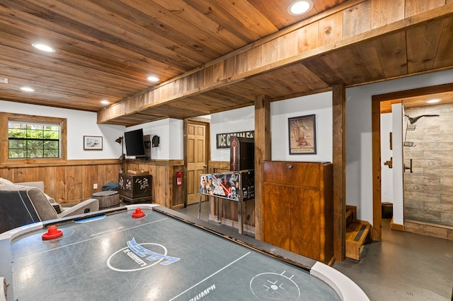 game room featuring wood ceiling and wood walls