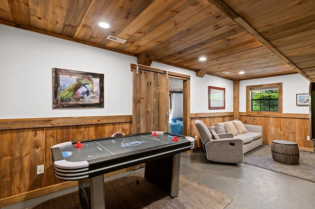 playroom with crown molding, wood ceiling, concrete flooring, and wood walls