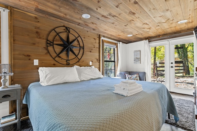 bedroom with wooden ceiling, wooden walls, and access to exterior