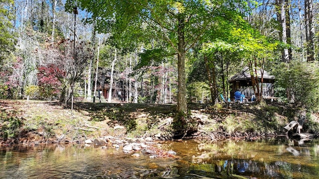 exterior space with a gazebo and a water view