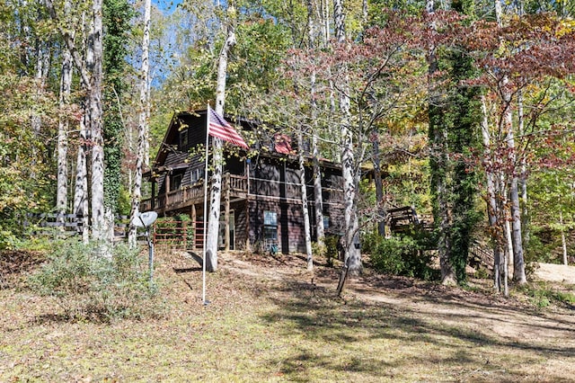 rear view of property featuring a wooden deck