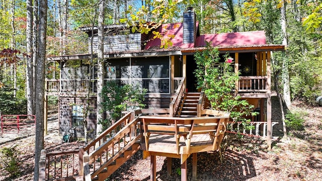 rear view of property with a sunroom