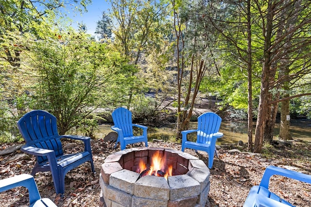 view of patio featuring a water view and a fire pit