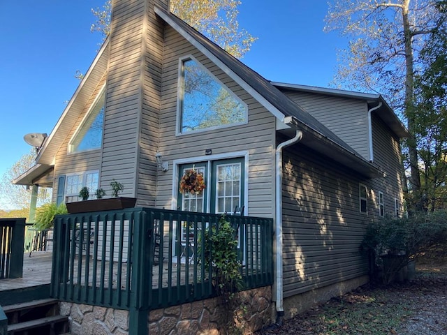 back of property featuring a wooden deck