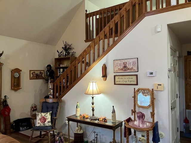 staircase featuring lofted ceiling