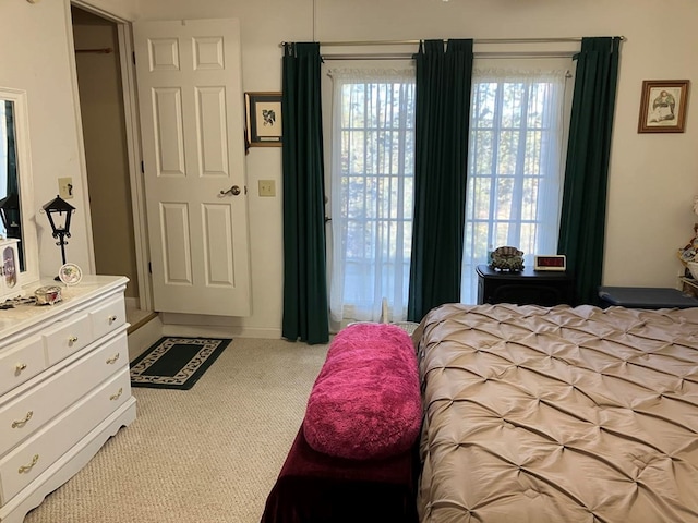 bedroom featuring light carpet