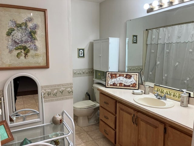 bathroom featuring vanity, toilet, and tile patterned flooring