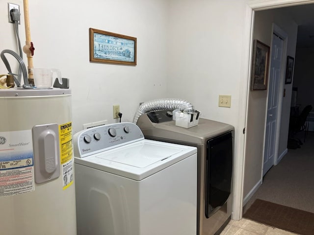 washroom with water heater, separate washer and dryer, and light tile patterned floors