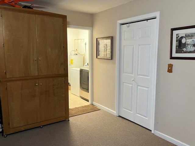 hallway featuring washer / clothes dryer and light colored carpet