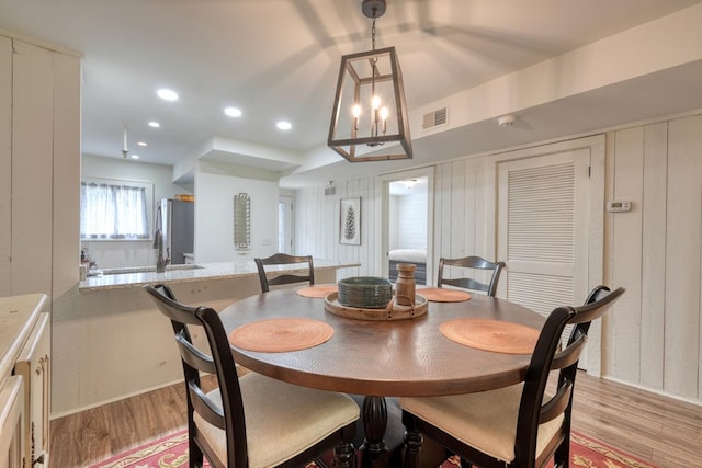 dining space with light wood-style flooring, visible vents, an inviting chandelier, and recessed lighting