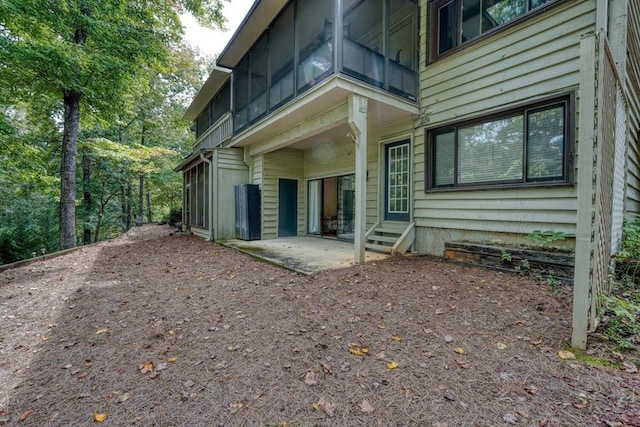 back of property featuring entry steps and a patio area