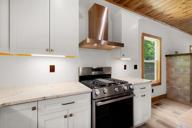 2562 Raven Cliff Rd, Ellijay, GA 30175 - kitchen with wall chimney range hood, wood ceiling, white cabinets, light wood-style flooring, and gas stove