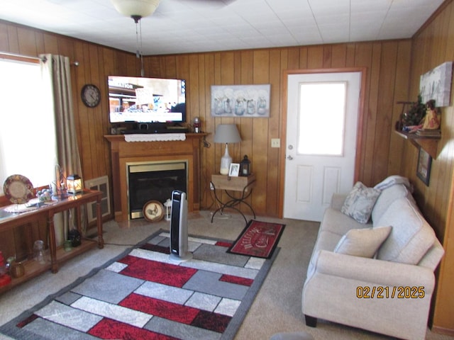 living room featuring a healthy amount of sunlight, carpet floors, and a glass covered fireplace