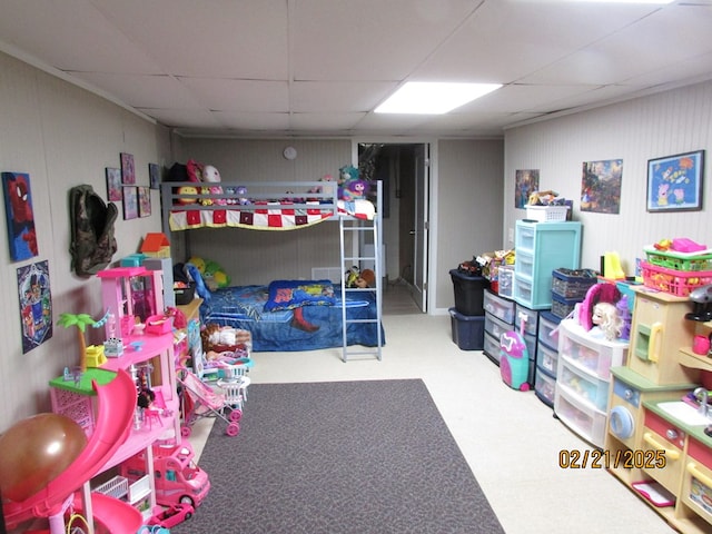 interior space with a drop ceiling and carpet flooring