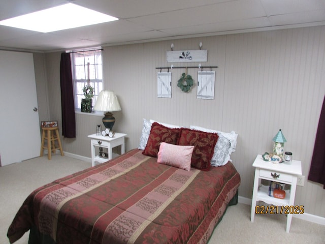 carpeted bedroom with a paneled ceiling