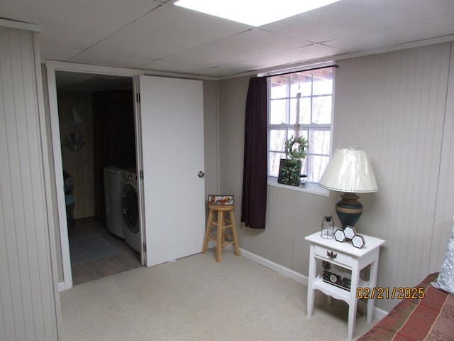 interior space featuring carpet floors, a drop ceiling, and washer and dryer