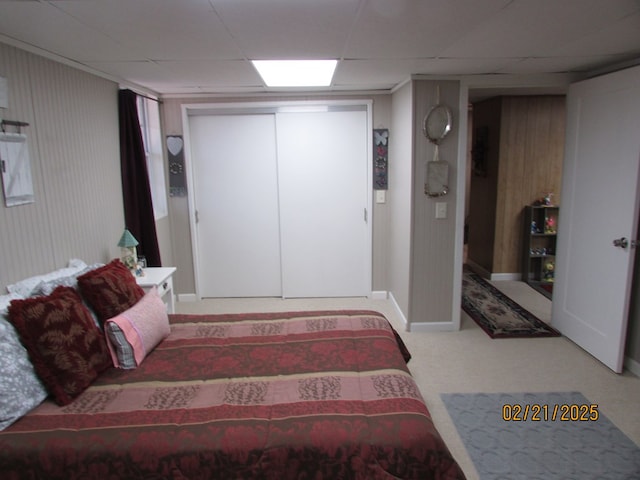 carpeted bedroom featuring a paneled ceiling