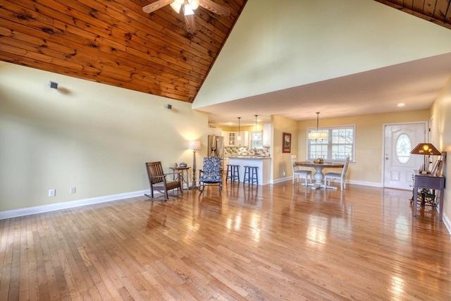 living room with high vaulted ceiling, wood ceiling, light hardwood / wood-style floors, and ceiling fan