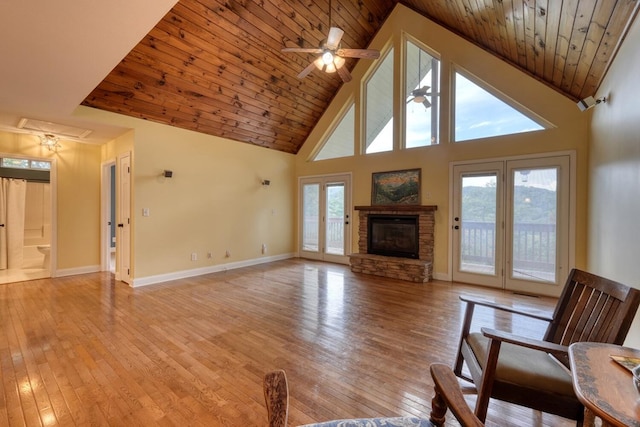 unfurnished living room featuring a healthy amount of sunlight, ceiling fan, and light wood-type flooring