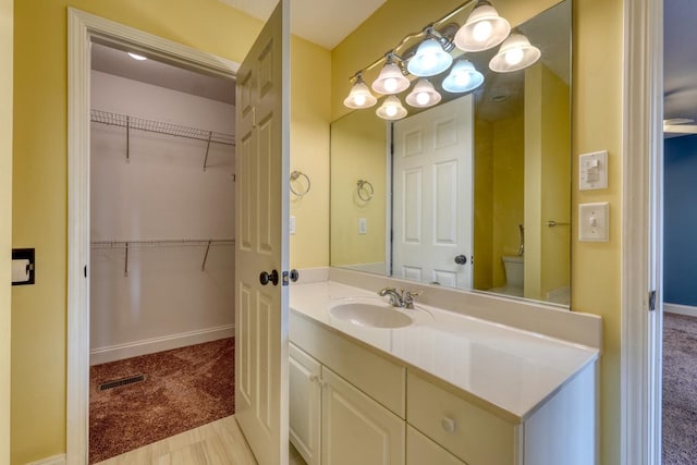 bathroom featuring vanity and toilet