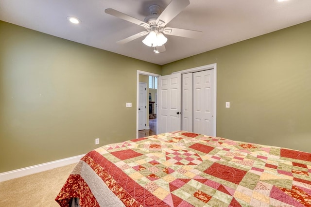 carpeted bedroom with ceiling fan and a closet