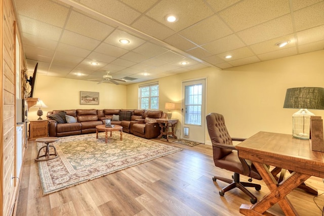 interior space featuring ceiling fan, a drop ceiling, and light hardwood / wood-style floors