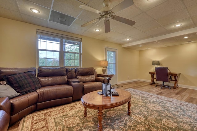 living room featuring a paneled ceiling, ceiling fan, and light hardwood / wood-style flooring