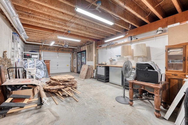 garage featuring stainless steel fridge and a workshop area