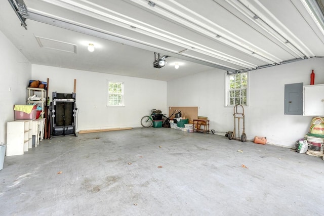 garage with a garage door opener and electric panel