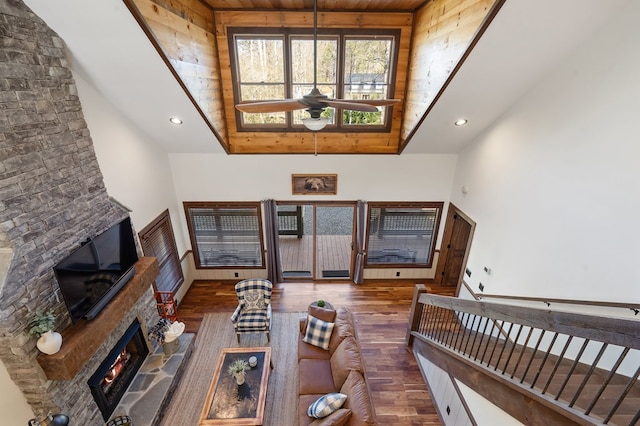 living room with ceiling fan, high vaulted ceiling, wooden ceiling, and dark hardwood / wood-style floors