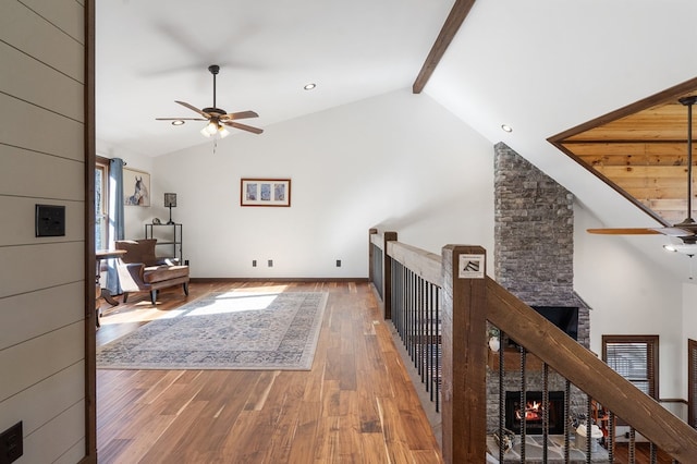 interior space featuring beam ceiling, high vaulted ceiling, and wood-type flooring