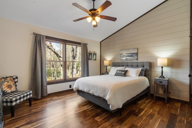 bedroom featuring dark wood-type flooring, ceiling fan, lofted ceiling, and wood walls