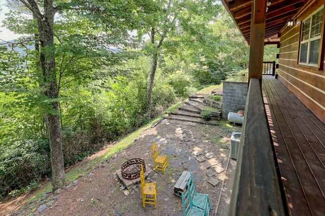 view of yard with an outdoor fire pit and a wooden deck