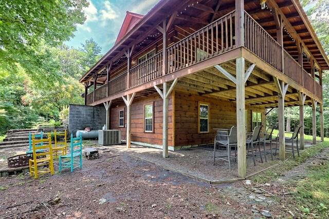 view of side of property with central AC, a patio area, and a deck