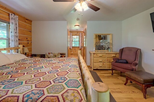 bedroom with multiple windows, light hardwood / wood-style flooring, and ceiling fan