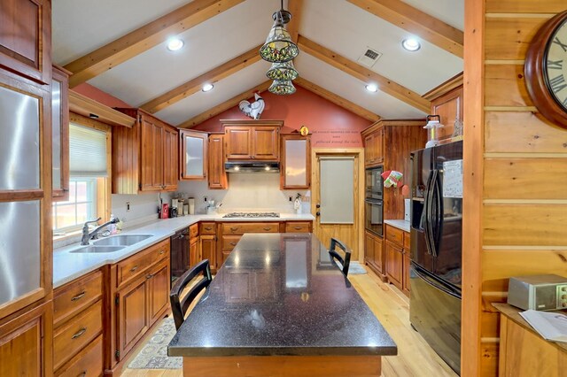 kitchen featuring black appliances, vaulted ceiling with beams, sink, a center island, and light hardwood / wood-style flooring