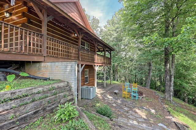 view of side of property featuring central AC unit and a wooden deck