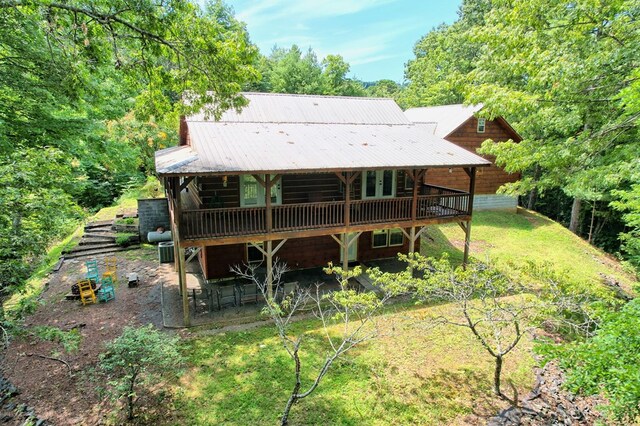 rear view of property with a wooden deck