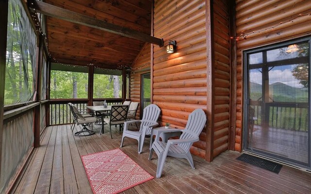 sunroom with vaulted ceiling, plenty of natural light, and visible vents