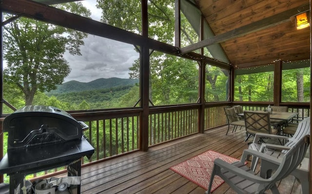 sunroom with a mountain view, wooden ceiling, and vaulted ceiling