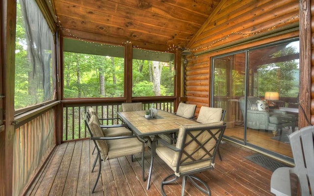 sunroom featuring a healthy amount of sunlight, wooden ceiling, and vaulted ceiling