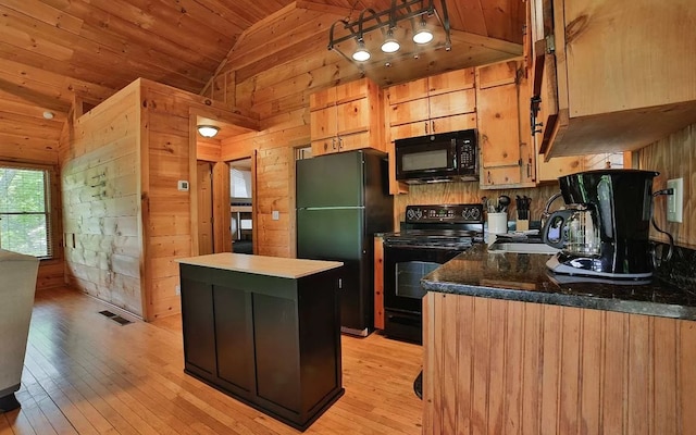 kitchen featuring visible vents, lofted ceiling, black appliances, wood walls, and wooden ceiling