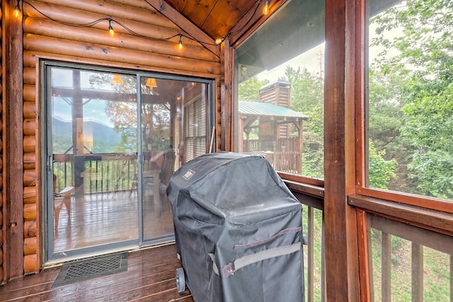 sunroom / solarium featuring visible vents and vaulted ceiling