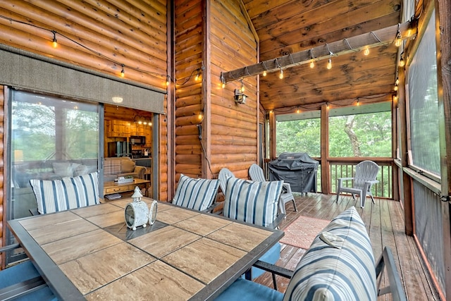 unfurnished dining area featuring rustic walls, a high ceiling, and wood-type flooring