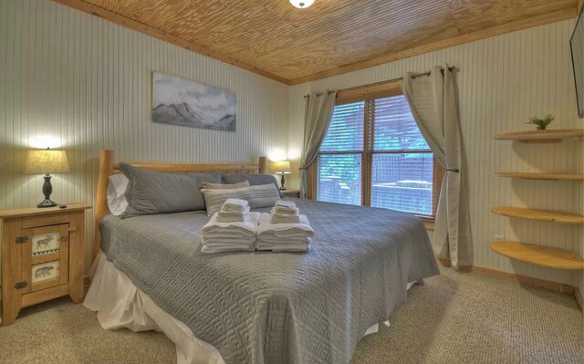 bedroom featuring wooden ceiling and carpet